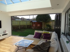Bi-folds open to reveal an expansive view of the garden